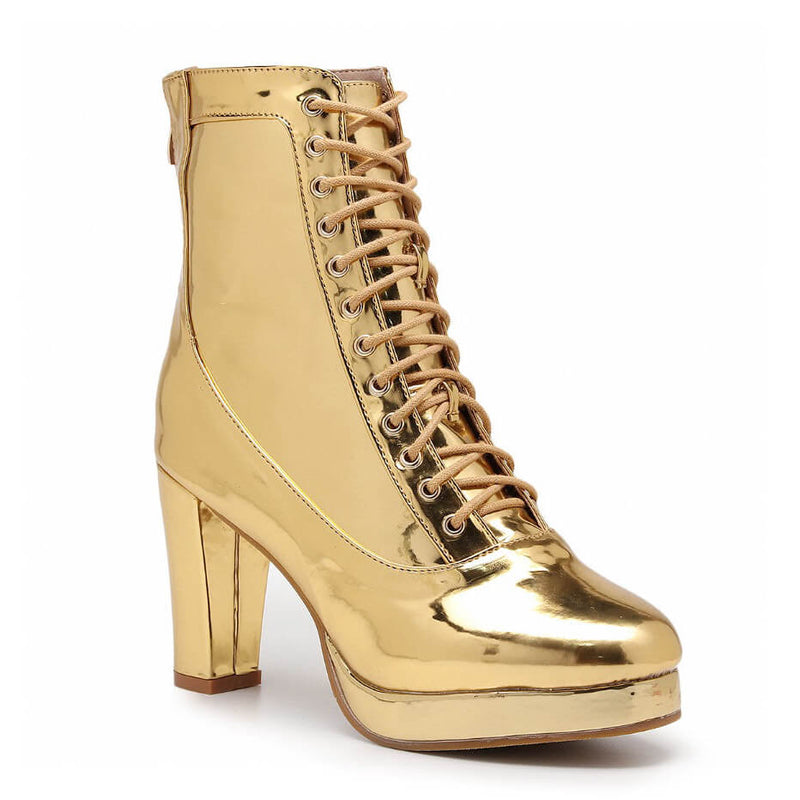 The Aadijay by Bailaqui is a shiny gold boot with thick platform heels, crafted from sleek vegan leather. It features a lace-up front, glossy finish, extends to the lower calf, and includes memory foam padding for comfort.
